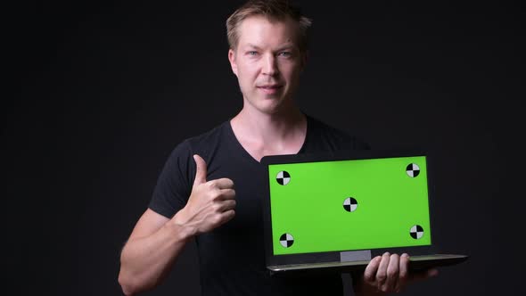 Young Handsome Man Using Laptop with Green Screen Chroma Key