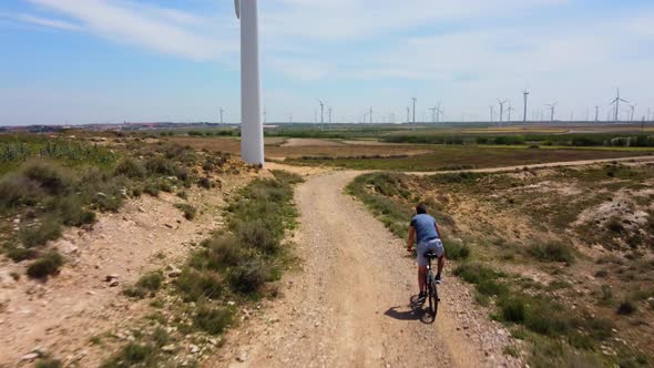 Man On Mountain Bike Amoung Windmills