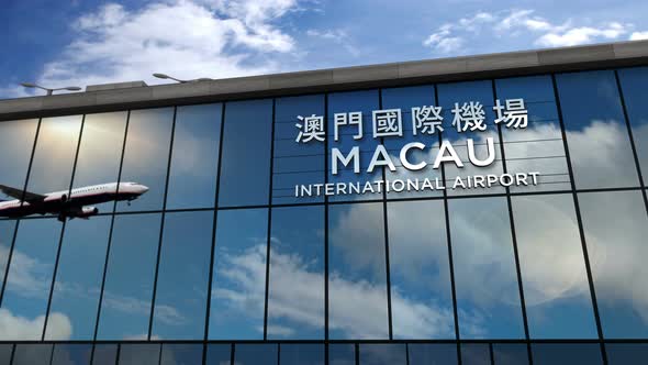 Airplane landing at Macau China airport mirrored in terminal