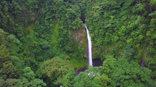 Flying toward stunning La Fortuna Waterfall in the Costa Rica rainforest, AERIAL