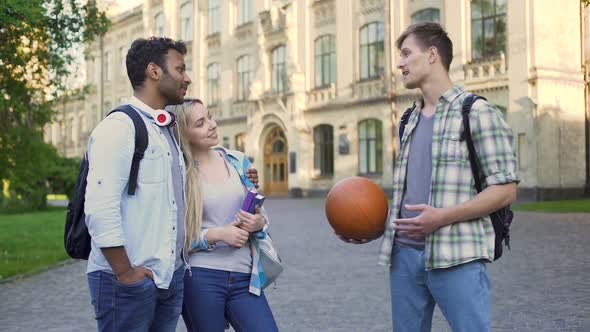 Young Man Talking With Multiracial Couple Near College, Carefree Student Life