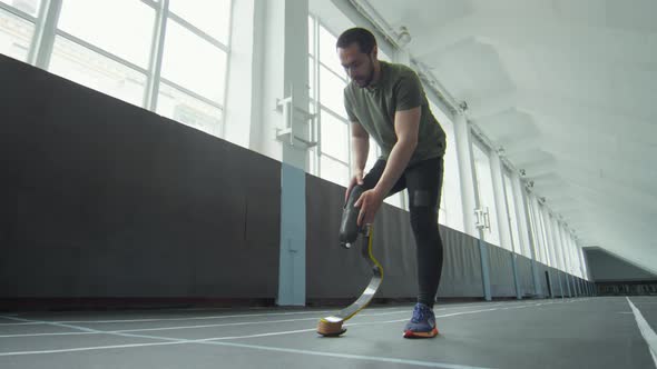 Athlete Putting on Prosthetic Running Blade and Jogging