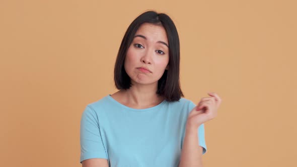 Pensive woman in blue t-shirt disagree with something