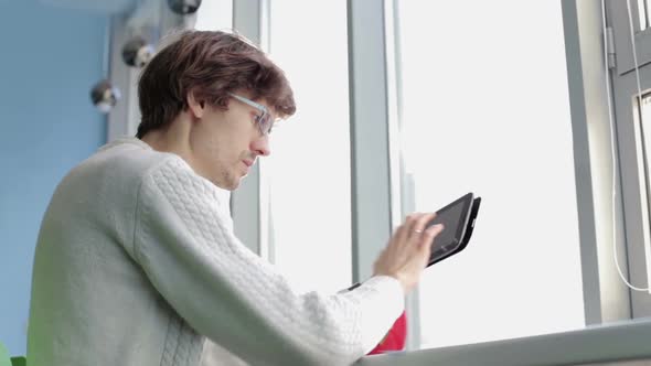 The business team works with construction drawings using a tablet.