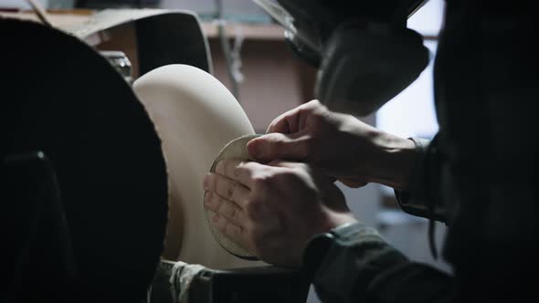 A Man in a Respirator Works on a Lathe in a Carpentry Workshop