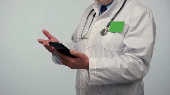 Male Doctor Consults Patient Using Mobile Phone