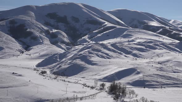 Snowy Mountain Ranges in Sunny Winter Day