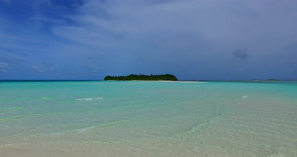 Daytime birds eye abstract shot of a sunshine white sandy paradise beach and aqua blue ocean backgro