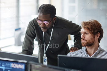 Black Man Mentoring IT Developer and Reviewing Code