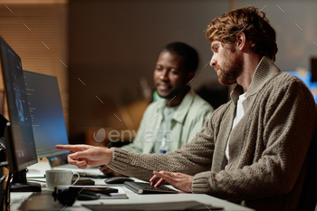 Colleagues reviewing data in office,