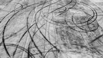 Tire track mark on asphalt tarmac road race track texture and background, Abstract background black.