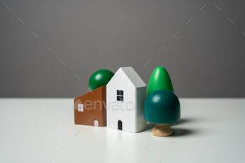 Figures of houses with trees. Realtor services. Buying and selling.