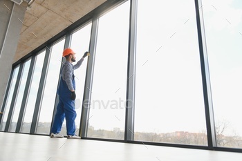 service man installing plastic window.