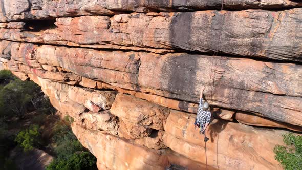 Male rock climber climbing mountain