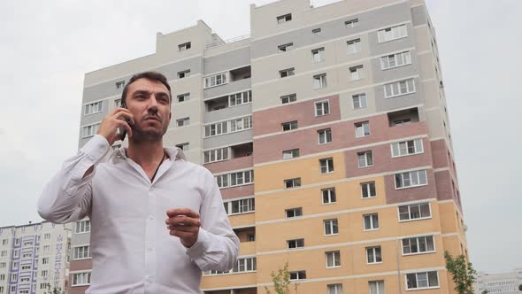 Serious Businessman Speaks Confidently on the Phone