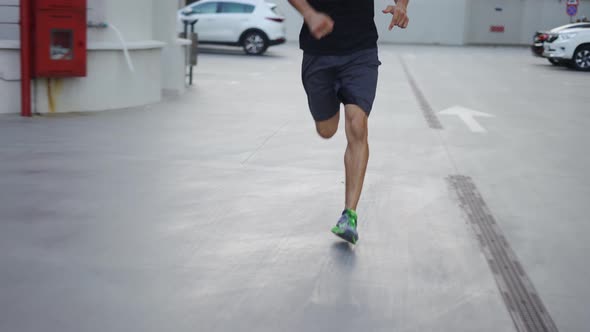 Man Runs Outdoors on the Parking Garage Slowmo