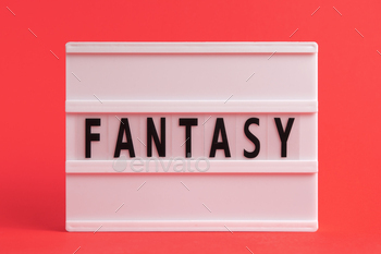 The word fantasy on lightbox isolated red background. Literary Genres