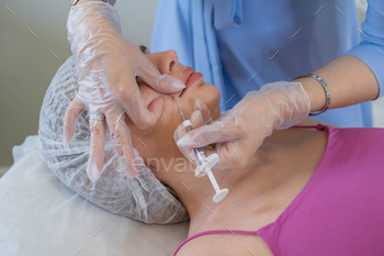 Focused care during a cosmetic injection, demonstrating the meticulous process of enhancing beauty