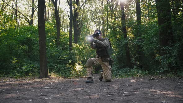 Soldier Aiming with Gun Wearing Virtual Reality Glasses Outdoors