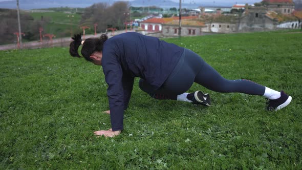 The Girl is Engaged in Sports on Green Grass in the Fresh Air