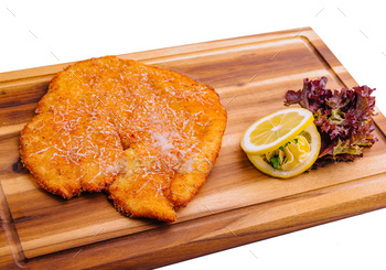Schnitzel with salad on a board