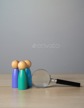 People figurines and magnifying glass. Diversity or unity.