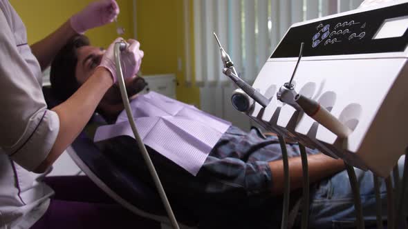 Dentist's Hand Taking Tool for Teeth Polishing