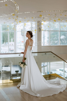 bride on the gold hotel stairs