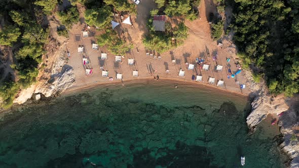 Flying Over Beach Umbrellas and Sunbeds on the Coast in Thassos Island, Greece
