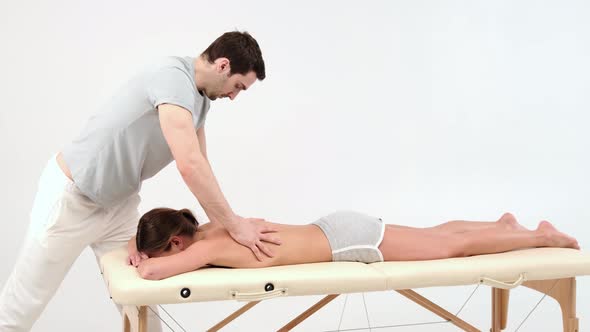 Young woman having massage. woman relaxing during back massage lying on massage table