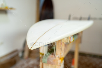 A surf board in a repair workshop
