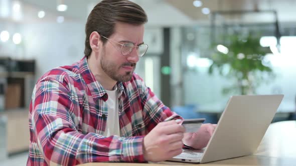 Man with Online Payment Failure on Laptop in Cafe