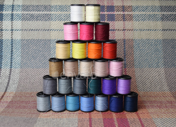 thread bobbins with colourful yarn or thread