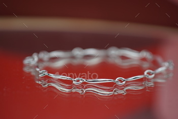 close up of the silver plated link bracelet on a red table