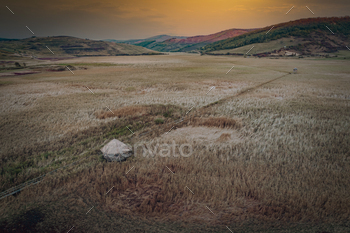 Scenic view of sunset over a grassy plain field