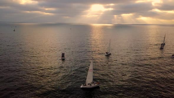 Aerial view of sailboats floating out to sea