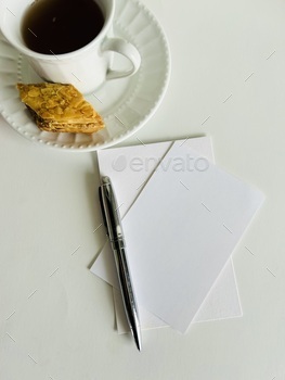 Coffee cup on desktop with notecards and pen