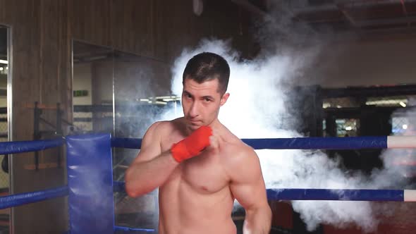 Young Caucasian Boxer Man in Smoky Ring