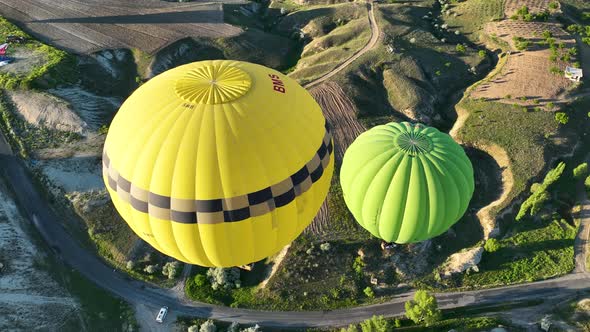 4K Aerial view of Goreme. Colorful hot air balloons fly over the valleys.