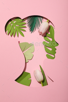 Paper female head with paper decorative leaves