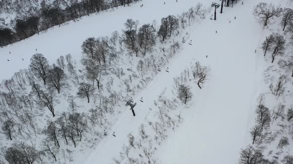 chair lift taking skiers on the snow mountain in winter at ski resort in nozawa onsen japan