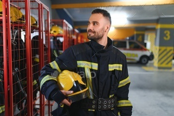 A firefighter puts on a fire uniform at the fire department