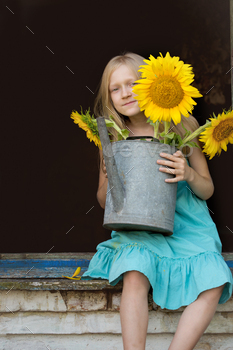 portrait of a little girl with a sunflower