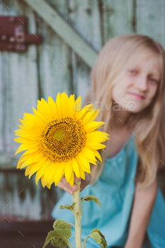 portrait of a little girl with a sunflower