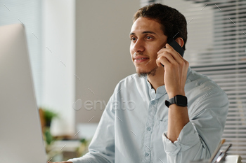 Male employee talking by mobile phone