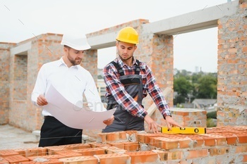 Builder and engineer on construction site