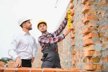 Builder and engineer on construction site