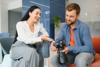 Photographer communicates with the client in the office.