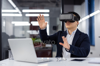 A man in a business suit uses augmented reality glasses, a businessman inside an office at a
