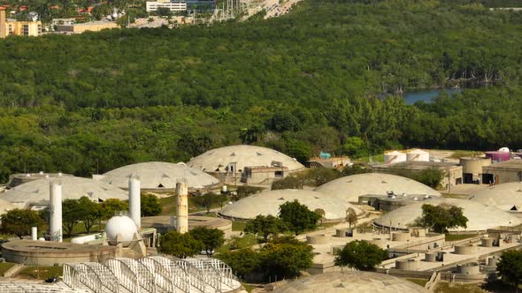 Aerial parallax of a water purification plant with nature in background 4k